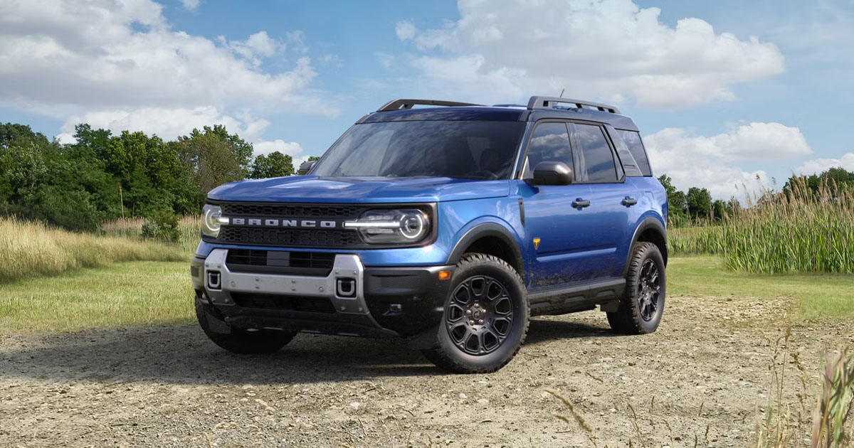 A blue Ford Bronco Sport parked in an open field.